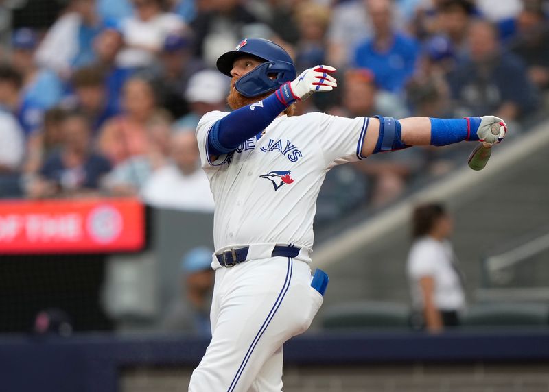 Jun 18, 2024; Toronto, Ontario, CAN; Toronto Blue Jays designated hitter Justin Turner (2) hits a single against the Boston Red Sox during the second inning at Rogers Centre. Mandatory Credit: John E. Sokolowski-USA TODAY Sports