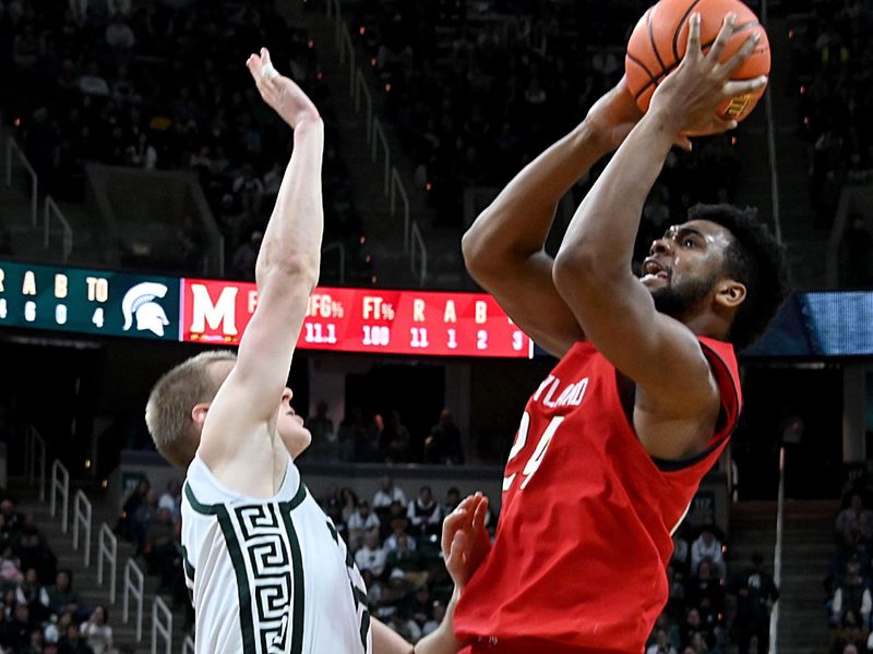 Feb 7, 2023; East Lansing, Michigan, USA;  Maryland Terrapins forward Donta Scott (24) tries a shot against Michigan State Spartans forward Joey Hauser (10) in the first half at Jack Breslin Student Events Center. Mandatory Credit: Dale Young-USA TODAY Sports