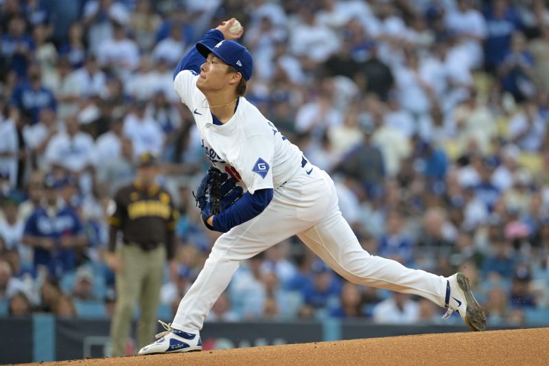 Oct 11, 2024; Los Angeles, California, USA; Los Angeles Dodgers pitcher Yoshinobu Yamamoto (18) pitches against the San Diego Padres in the first inning during game five of the NLDS for the 2024 MLB Playoffs at Dodger Stadium. Mandatory Credit: Jayne Kamin-Oncea-Imagn Images