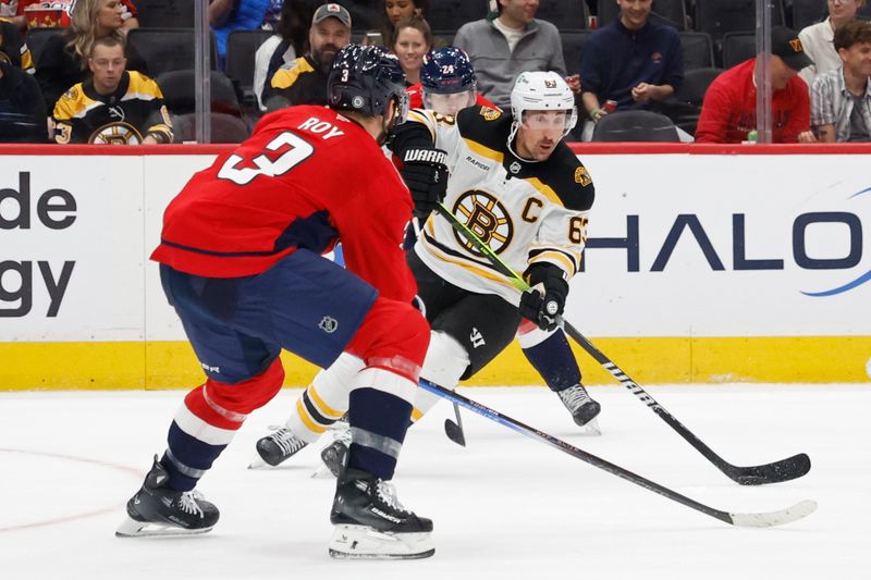 Oct 5, 2024; Washington, District of Columbia, USA; Boston Bruins left wing Brad Marchand (63) skates with the puck as Washington Capitals defenseman Matt Roy (3) defends in the second period at Capital One Arena. Mandatory Credit: Geoff Burke-Imagn Images