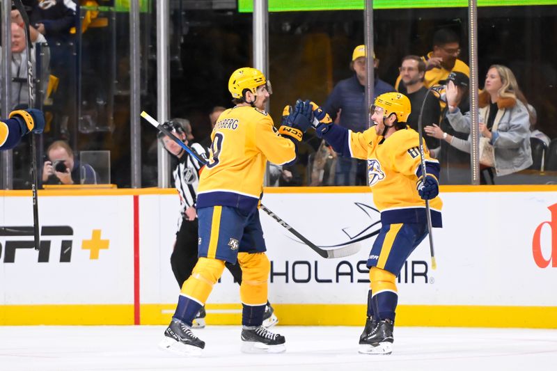 Oct 10, 2024; Nashville, Tennessee, USA;  Nashville Predators left wing Filip Forsberg (9) celebrates the goal of Nashville Predators center Jonathan Marchessault (81) during the second period at Bridgestone Arena. Mandatory Credit: Steve Roberts-Imagn Images