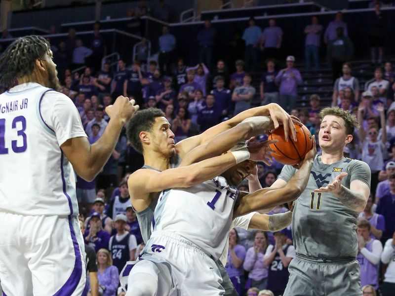 Feb 26, 2024; Manhattan, Kansas, USA; Kansas State Wildcats forward David N'Guessan (1) is fouled by West Virginia Mountaineers center Jesse Edwards (7) during overtime at Bramlage Coliseum. Mandatory Credit: Scott Sewell-USA TODAY Sports