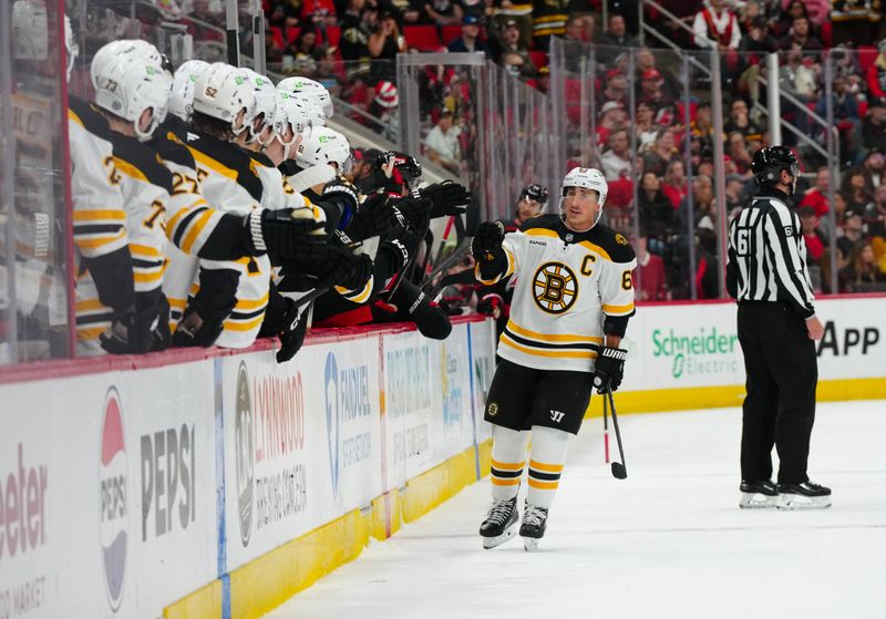 Oct 31, 2024; Raleigh, North Carolina, USA;  Boston Bruins left wing Brad Marchand (63) celebrates his goal against the Carolina Hurricanes during the first period at Lenovo Center. Mandatory Credit: James Guillory-Imagn Images