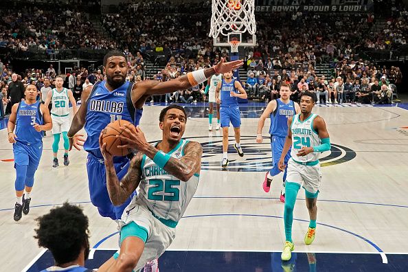 DALLAS, TEXAS - NOVEMBER 05: P.J. Washington #25 of the Charlotte Hornets drives to the basket as Kyrie Irving #11 of the Dallas Mavericks defends during the first half at American Airlines Center on November 05, 2023 in Dallas, Texas. NOTE TO USER: User expressly acknowledges and agrees that, by downloading and or using this photograph, User is consenting to the terms and conditions of the Getty Images License Agreement. (Photo by Sam Hodde/Getty Images)