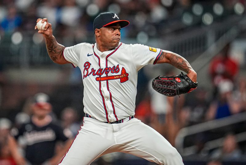Sep 23, 2025; Cumberland, Georgia, USA; Atlanta Braves relief pitcher Raisel Iglesias (26)  pitches against the Washington Nationals during the ninth inning at Truist Park. Mandatory Credit: Dale Zanine-Imagn Images