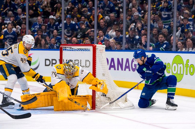 Apr 23, 2024; Vancouver, British Columbia, CAN; Nashville Predators defenseman Alexandre Carrier (45) watches as goalie Juuse Saros (74) makes a save on Vancouver Canucks forward Pius Suter (24) during the third period in game two of the first round of the 2024 Stanley Cup Playoffs at Rogers Arena. Mandatory Credit: Bob Frid-USA TODAY Sports