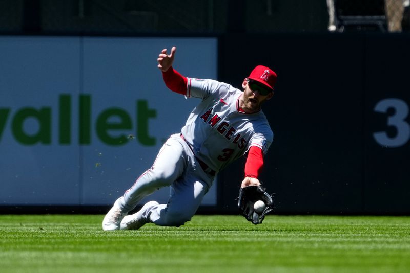 Jun 25, 2023; Denver, Colorado, USA; Los Angeles Angels left fielder Taylor Ward (3) attempts to field the ball in the fourth inning against the Colorado Rockies at Coors Field. Mandatory Credit: Ron Chenoy-USA TODAY Sports