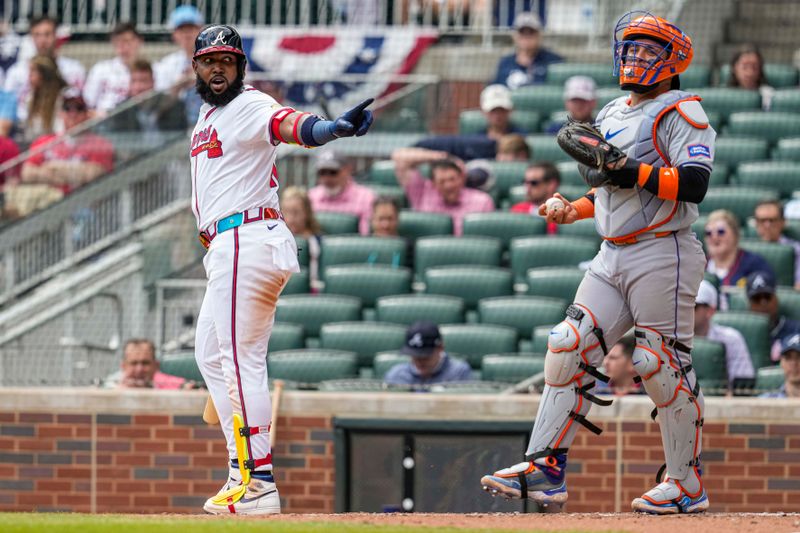 Apr 11, 2024; Cumberland, Georgia, USA; Atlanta Braves designated hitter Marcell Ozuna (20) reacts to New York Mets catcher Francisco Alvarez (4) asking for a strike call during the eighth inning at Truist Park. Mandatory Credit: Dale Zanine-USA TODAY Sports