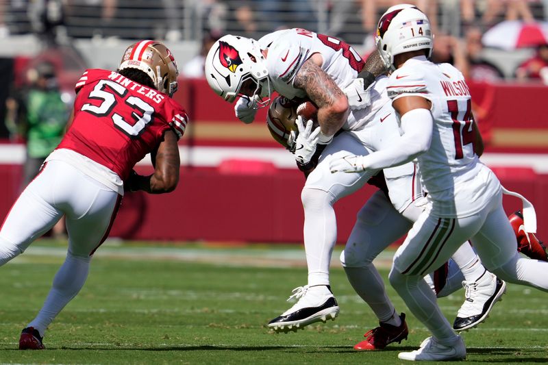 Arizona Cardinals tight end Trey McBride, top, runs against San Francisco 49ers linebacker Dee Winters (53) during the first half of an NFL football game in Santa Clara, Calif., Sunday, Oct. 6, 2024. (AP Photo/Godofredo A. Vásquez)