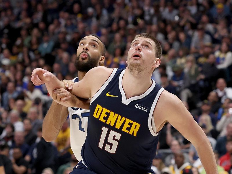 DENVER, COLORADO - APRIL 10: Nikola Jokic #15 of the Denver Nuggets boxes out Rudy Gobert #27 of the Minnesota Timberwolves during the third quarter at Ball Arena on April 10, 2024 in Denver, Colorado. NOTE TO USER: User expressly acknowledges and agrees that, by downloading and or using this photograph, User is consenting to the terms and conditions of the Getty Images License Agreement.  (Photo by Matthew Stockman/Getty Images)