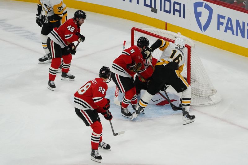 Dec 28, 2025; Chicago, Illinois, USA; Pittsburgh Penguins right wing Justin Brazeau (16) scores a goal against Chicago Blackhawks goaltender Spencer Knight (30) during the first period at United Center. Mandatory Credit: David Banks-Imagn Images
