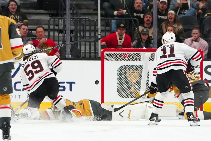 Dec 2, 2025; Las Vegas, Nevada, USA; Chicago Blackhawks left wing Tyler Bertuzzi (59) scores a goal against Vegas Golden Knights goaltender Carter Hart (79) during the second period at T-Mobile Arena. Mandatory Credit: Stephen R. Sylvanie-Imagn Images