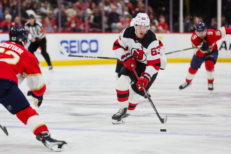 Jan 13, 2024; Sunrise, Florida, USA; New Jersey Devils left wing Jesper Bratt (63) moves the puck against the Florida Panthers during the first period at Amerant Bank Arena. Mandatory Credit: Sam Navarro-USA TODAY Sports