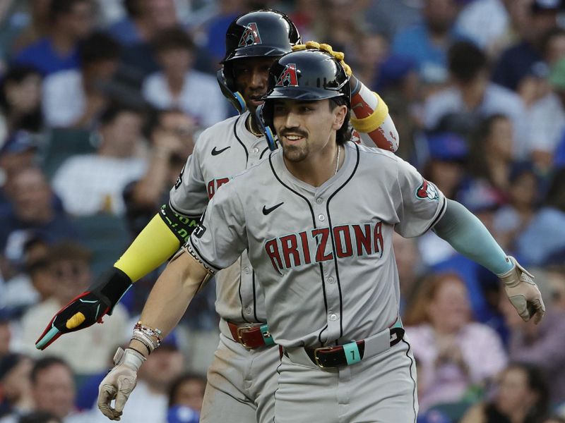 Jul 20, 2024; Chicago, Illinois, USA; Arizona Diamondbacks outfielder Corbin Carroll (7) celebrates with shortstop Geraldo Perdomo (2) after hitting a two-run home run against the Chicago Cubs during the fifth inning at Wrigley Field. Mandatory Credit: Kamil Krzaczynski-USA TODAY Sports