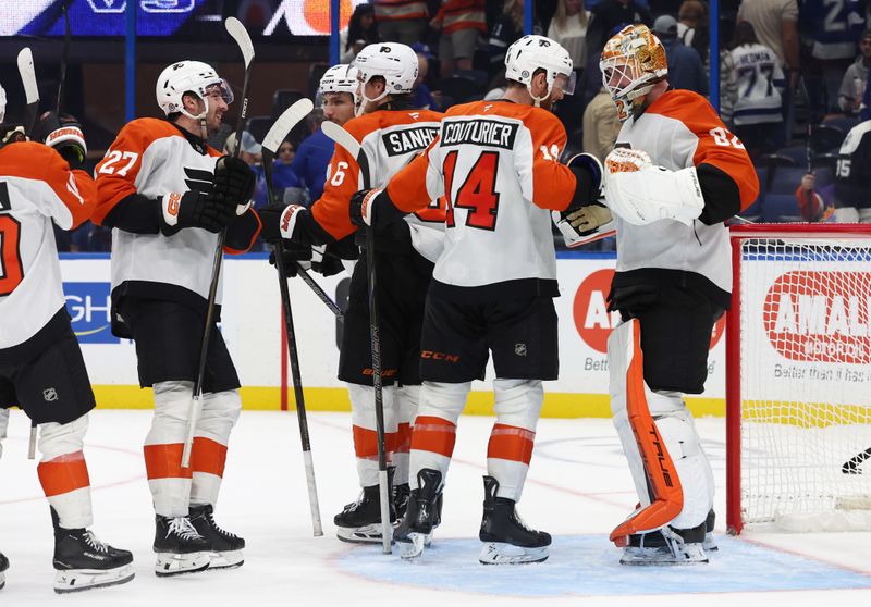 Nov 7, 2024; Tampa, Florida, USA; Philadelphia Flyers center Sean Couturier (14), goaltender Ivan Fedotov (82) and teammates celebrate after they defeated the Tampa Bay Lightning at Amalie Arena. Mandatory Credit: Kim Klement Neitzel-Imagn Images