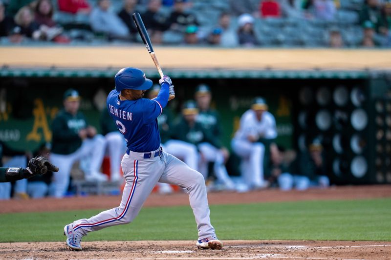 Aug 8, 2023; Oakland, California, USA;  Texas Rangers second baseman Marcus Semien (2) hits a RBI single against the Oakland Athletics during the fourth inning at Oakland-Alameda County Coliseum. Mandatory Credit: Neville E. Guard-USA TODAY Sports