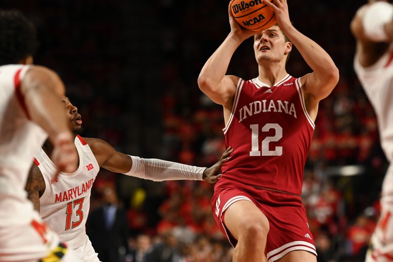 Jan 31, 2023; College Park, Maryland, USA;  Indiana Hoosiers forward Miller Kopp (12) looks to pass to the middle as Maryland Terrapins guard Hakim Hart (13) defends during the first half at Xfinity Center. Mandatory Credit: Tommy Gilligan-USA TODAY Sports