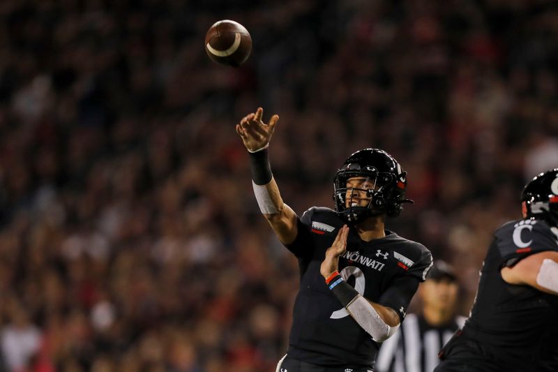 Oct 8, 2021; Cincinnati, Ohio, USA; Cincinnati Bearcats quarterback Desmond Ridder (9) throws a pass against the Temple Owls in the first half at Nippert Stadium. Mandatory Credit: Katie Stratman-USA TODAY Sports