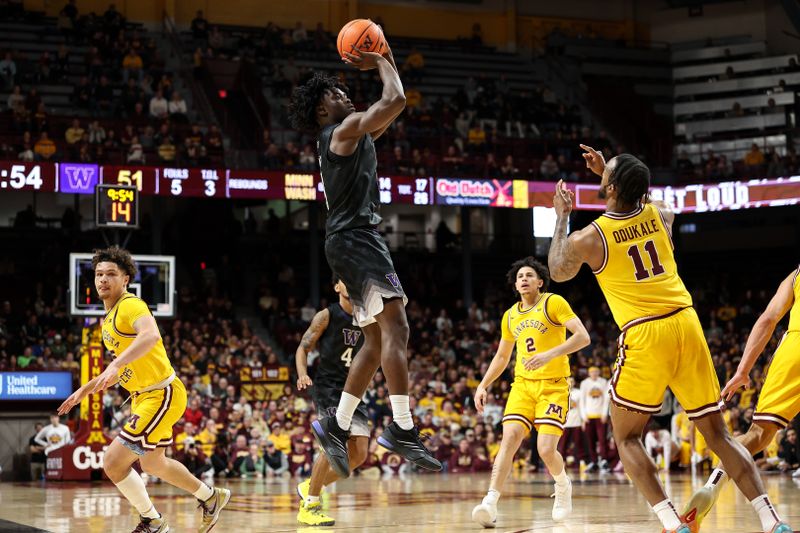Feb 1, 2025; Minneapolis, Minnesota, USA; Washington Huskies guard Zoom Diallo (9) shoots as Minnesota Golden Gophers guard Femi Odukale (11) defends during the second half at Williams Arena. Mandatory Credit: Matt Krohn-Imagn Images