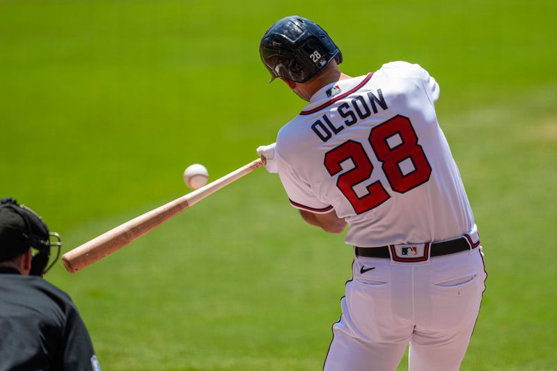 Jun 28, 2023; Cumberland, Georgia, USA; Atlanta Braves first baseman Matt Olson (28) hits a double to drive in a run against the Minnesota Twins during the first inning at Truist Park. Mandatory Credit: Dale Zanine-USA TODAY Sports