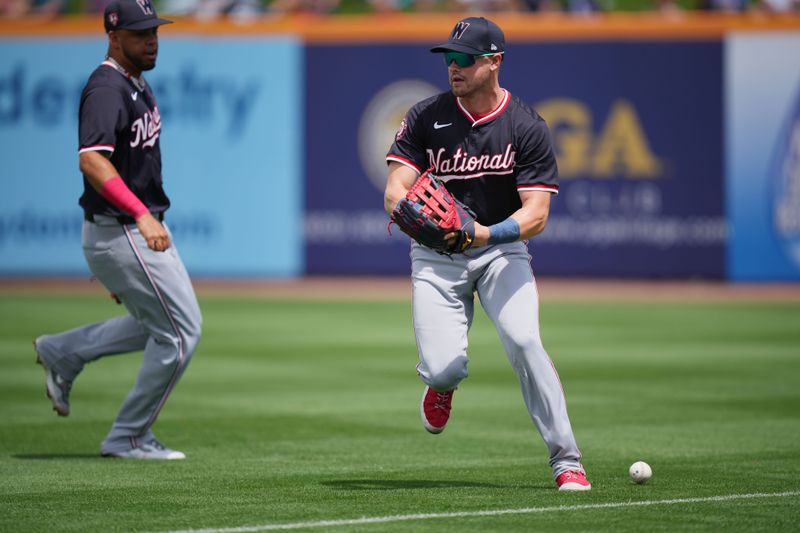 Mar 24, 2024; Port St. Lucie, Florida, USA;  A base hit  drops in between Washington Nationals right fielder Lane Thomas, right, and second baseman Luis Garcia Jr. in the second inning against the New York Mets at Clover Park. Mandatory Credit: Jim Rassol-USA TODAY Sports