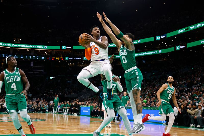 BOSTON, MA - DECEMBER 8: RJ Barrett #9 of the New York Knicks goes to the basket against Jayson Tatum #0 of the Boston Celtics during the first quarter at TD Garden on December 8, 2023 in Boston, Massachusetts. NOTE TO USER: User expressly acknowledges and agrees that, by downloading and/or using this Photograph, user is consenting to the terms and conditions of the Getty Images License Agreement. (Photo By Winslow Townson/Getty Images)