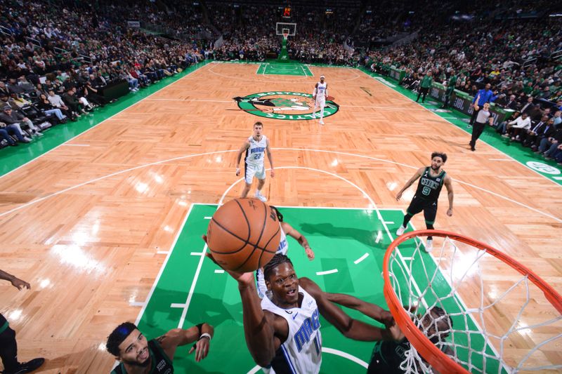 BOSTON, MA - DECEMBER 16: Mo Bamba #11 of the Orlando Magic drives to the basket during the game against the Boston Celtics on December 16, 2022 at the TD Garden in Boston, Massachusetts.  NOTE TO USER: User expressly acknowledges and agrees that, by downloading and or using this photograph, User is consenting to the terms and conditions of the Getty Images License Agreement. Mandatory Copyright Notice: Copyright 2022 NBAE  (Photo by Brian Babineau/NBAE via Getty Images)