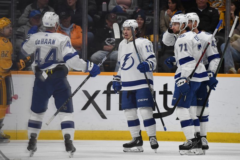 Dec 7, 2023; Nashville, Tennessee, USA; Tampa Bay Lightning center Alex Barre-Boulet (12) celebrates with teammates after a goal during the first period against the Nashville Predators at Bridgestone Arena. Mandatory Credit: Christopher Hanewinckel-USA TODAY Sports