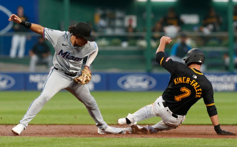 Sep 10, 2024; Pittsburgh, Pennsylvania, USA;  Pittsburgh Pirates third baseman Isiah Kiner-Falefa (7) beats Miami Marlins shortstop Javier Sanoja (86) to second base to reach base safely on a fielders choice during the third inning against at PNC Park. Mandatory Credit: Charles LeClaire-Imagn Images