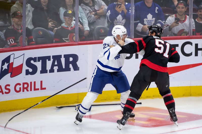 Sep 24, 2024; Ottawa, Ontario, CAN; Toronto Maple Leafs right wing Pontus Holmberg (29) fights with Ottawa Senators left wing Cole Reinhardt (51) in the third period at the Canadian Tire Centre. Mandatory Credit: Marc DesRosiers-Imagn Images