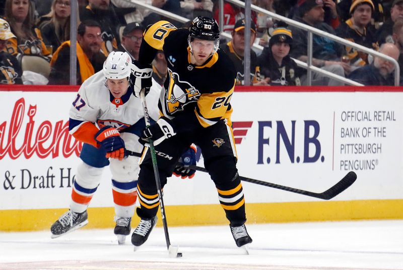 Feb 20, 2024; Pittsburgh, Pennsylvania, USA; Pittsburgh Penguins center Lars Eller (20) moves the puck up ice as New York Islanders left wing Matt Martin (17) chases during the first period at PPG Paints Arena. New York won 5-4 in overtime. Mandatory Credit: Charles LeClaire-USA TODAY Sports