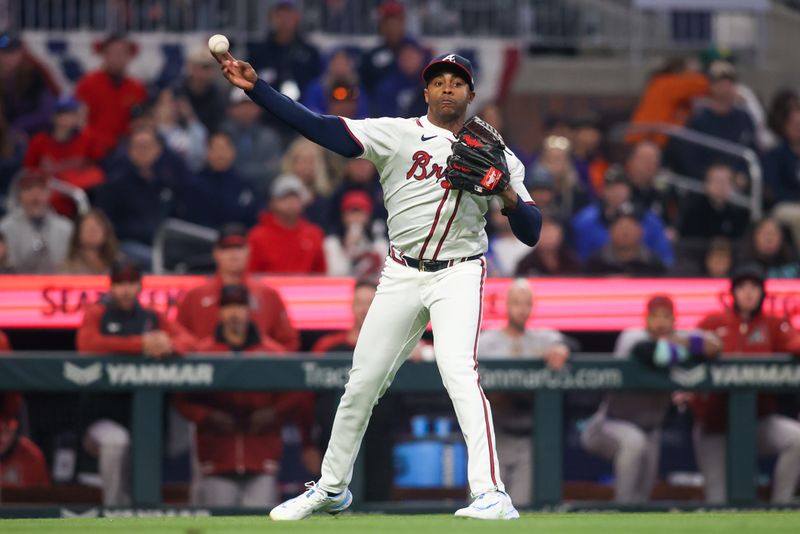 Apr 6, 2024; Atlanta, Georgia, USA; Atlanta Braves relief pitcher Raisel Iglesias (26) throws a runner out at first against the Arizona Diamondbacks in the ninth inning at Truist Park. Mandatory Credit: Brett Davis-USA TODAY Sports
