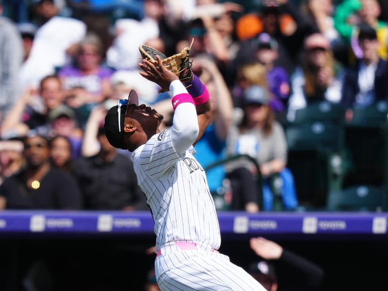 May 12, 2024; Denver, Colorado, USA; Colorado Rockies first base Elehuris Montero (44) prepares to field the ball in the eighth inning against the Texas Rangers at Coors Field. Mandatory Credit: Ron Chenoy-USA TODAY Sports