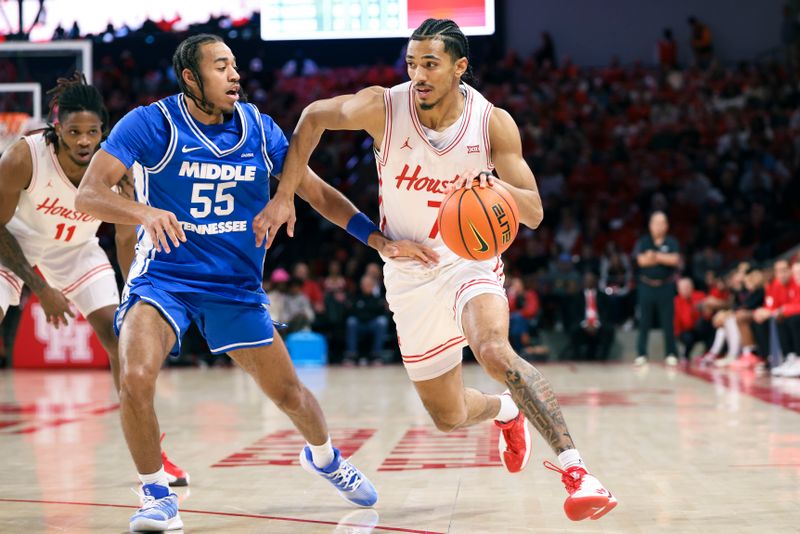 Dec 29, 2025; Houston, Texas, USA; Houston Cougars guard Milos Uzan (7) drives witht the ball as Middle Tennessee Blue Raiders guard Sean Smith (55) defends during the first half at Fertitta Center. Mandatory Credit: Troy Taormina-Imagn Images