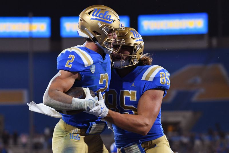 Sep 18, 2021; Pasadena, California, USA;  UCLA Bruins wide receiver Kyle Philips (2) celebrates with tight end Greg Dulcich (85) after making a catch for a touchdown against Fresno State Bulldogs defensive back Bralyn Lux (38) in the fourth quarter at Rose Bowl. Mandatory Credit: Richard Mackson-USA TODAY Sports