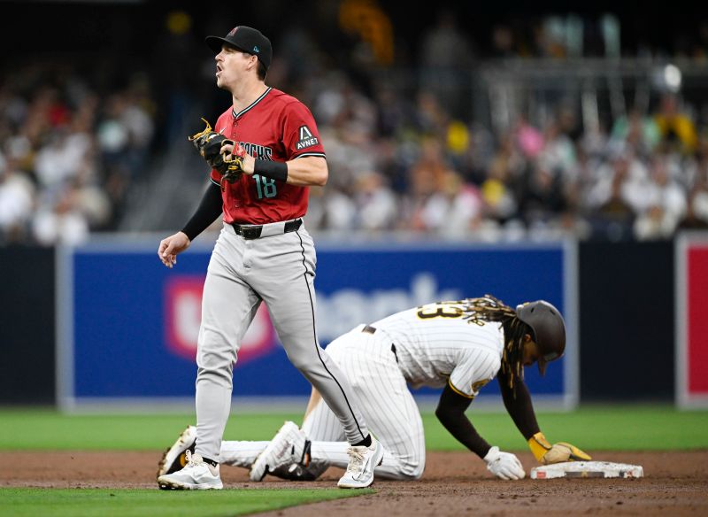 Jun 6, 2024; San Diego, California, USA; Arizona Diamondbacks shortstop Kevin Newman (18) reacts after tagging San Diego Padres right fielder Fernando Tatis Jr. (23) out at second base during the third inning at Petco Park. Mandatory Credit: Denis Poroy-USA TODAY Sports at Petco Park. 