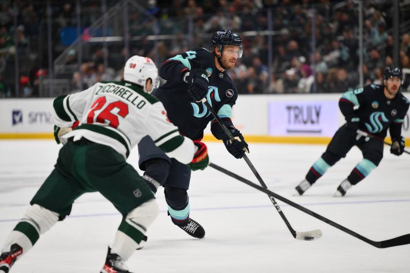 Mar 4, 2025; Seattle, Washington, USA; Seattle Kraken defenseman Jamie Oleksiak (24) shoots the puck against the Minnesota Wild during the first period at Climate Pledge Arena. Mandatory Credit: Steven Bisig-Imagn Images