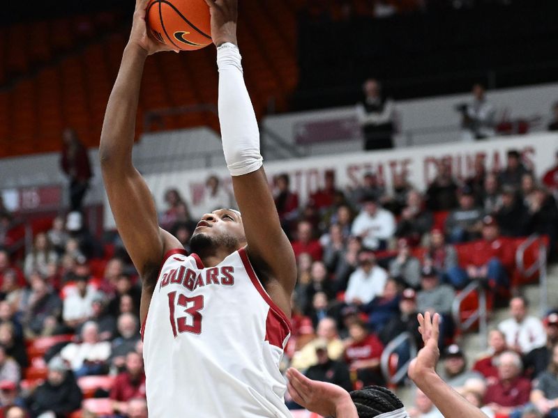 Jan 13, 2024; Pullman, Washington, USA; Washington State Cougars forward Isaac Jones (13) shoots the ball against Arizona Wildcats guard Kylan Boswell (4) in the second half at Friel Court at Beasley Coliseum. Washington State won 73-70. Mandatory Credit: James Snook-USA TODAY Sports