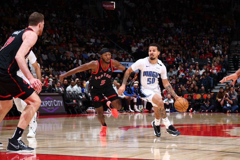 TORONTO, CANADA - JANUARY 3: Cole Anthony #50 of the Orlando Magic handles the ball during the game against the Toronto Raptors on January 3, 2025 at the Scotiabank Arena in Toronto, Ontario, Canada.  NOTE TO USER: User expressly acknowledges and agrees that, by downloading and or using this Photograph, user is consenting to the terms and conditions of the Getty Images License Agreement.  Mandatory Copyright Notice: Copyright 2025 NBAE (Photo by Vaughn Ridley/NBAE via Getty Images)