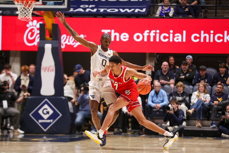 Feb 18, 2026; Morgantown, West Virginia, USA; Utah Utes forward Josh Hayes (7) dribbles against West Virginia Mountaineers forward Brenen Lorient (0) during the second half at Hope Coliseum. Mandatory Credit: Ben Queen-Imagn Images