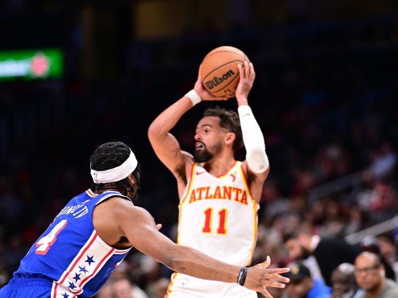 ATLANTA, GA - OCTOBER 14:  Trae Young #11 of the Atlanta Hawks looks to pass the ball during the game against the Philadelphia 76ers during a preseason game on October 14, 2024 at State Farm Arena in Atlanta, Georgia.  NOTE TO USER: User expressly acknowledges and agrees that, by downloading and/or using this Photograph, user is consenting to the terms and conditions of the Getty Images License Agreement. Mandatory Copyright Notice: Copyright 2024 NBAE (Photo by Adam Hagy/NBAE via Getty Images)