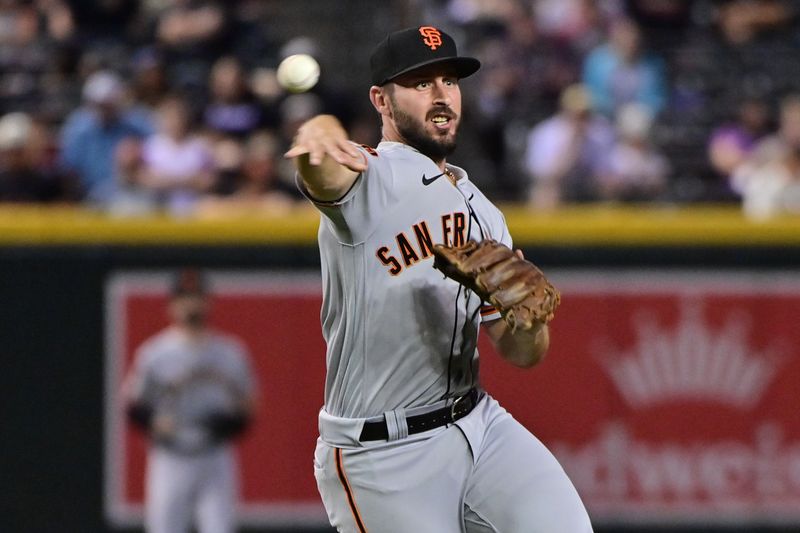 Sep 19, 2023; Phoenix, Arizona, USA; San Francisco Giants shortstop Paul DeJong (18) throws to first base in the eighth inning against the Arizona Diamondbacks at Chase Field. Mandatory Credit: Matt Kartozian-USA TODAY Sports