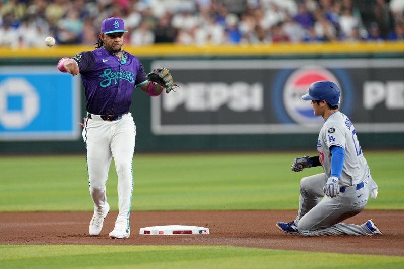 May 10, 2025; Phoenix, Arizona, USA; Arizona Diamondbacks second base Ketel Marte (4) throws to first for a double play after forcing out Arizona Diamondbacks manager Torey Lovullo (17) at second during the first inning at Chase Field. Mandatory Credit: Joe Camporeale-Imagn Images