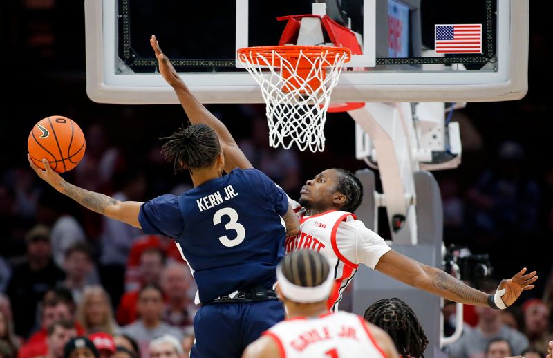 Jan 20, 2024; Columbus, Ohio, USA;  Penn State Nittany Lions guard Nick Kern Jr. (3) takes the ball to the basket as Ohio State Buckeyes center Felix Okpara (34) defends during the second half at Value City Arena. Mandatory Credit: Joseph Maiorana-USA TODAY Sports