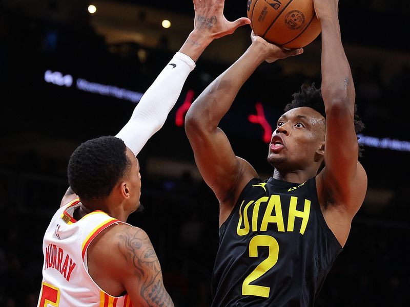 ATLANTA, GEORGIA - FEBRUARY 27:  Collin Sexton #2 of the Utah Jazz attempts a shot against Dejounte Murray #5 of the Atlanta Hawks during the third quarter at State Farm Arena on February 27, 2024 in Atlanta, Georgia.  NOTE TO USER: User expressly acknowledges and agrees that, by downloading and/or using this photograph, user is consenting to the terms and conditions of the Getty Images License Agreement.  (Photo by Kevin C. Cox/Getty Images)