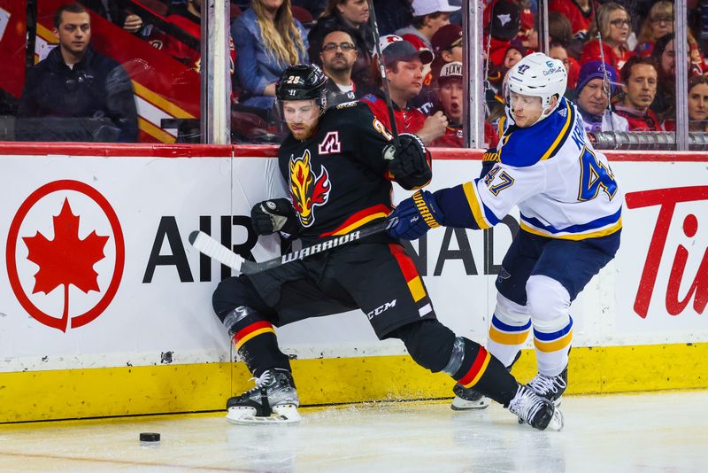 Jan 23, 2024; Calgary, Alberta, CAN; Calgary Flames center Elias Lindholm (28) and St. Louis Blues defenseman Torey Krug (47) battles for the puck during the second period at Scotiabank Saddledome. Mandatory Credit: Sergei Belski-USA TODAY Sports