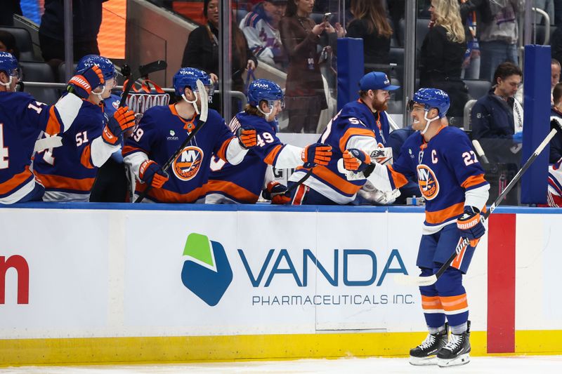 Dec 27, 2025; Elmont, New York, USA;  New York Islanders left wing Anders Lee (27) celebrates with his teammates after scoring a goal in the first period against the New York Rangers at UBS Arena. Mandatory Credit: Wendell Cruz-Imagn Images