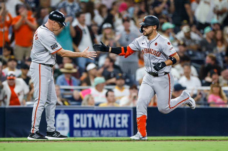 Sep 6, 2024; San Diego, California, USA; San Francisco Giants designated hitter Michael Conforto (8) celebrates with San Francisco Giants third base coach Matt Williams (9) after hitting a one run home run during the sixth inning against the San Diego Padres at Petco Park. Mandatory Credit: David Frerker-Imagn Images