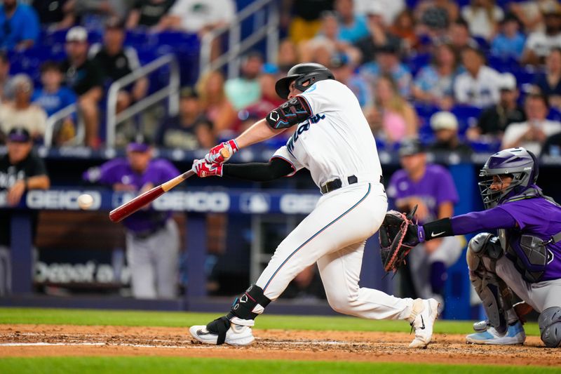 Jul 23, 2023; Miami, Florida, USA; Miami Marlins catcher Nick Fortes (4) hits a single against the Colorado Rockies during the fifth inning at loanDepot Park. Mandatory Credit: Rich Storry-USA TODAY Sports