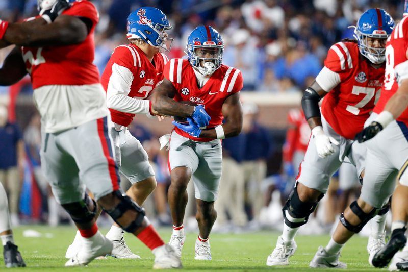 Oct 28, 2023; Oxford, Mississippi, USA; Mississippi Rebels quarterback Jaxson Dart (2) hands the ball off to running back Quinshon Judkins (4) during the first half against the Vanderbilt Commodores at Vaught-Hemingway Stadium. Mandatory Credit: Petre Thomas-USA TODAY Sports